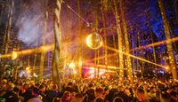 Best-herder Festival under the trees, beams of light shining onto crystal balls producing electric atmosphere.