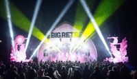 The Big Retreat Festival main stage at night, with large crowd in the foreground.