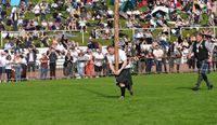 A man preparing to toss the caber.