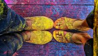 Feet and shoes of colour Festival goers.