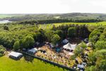 An aerial view of The Big Retreat site, with activity tents and camping areas surrounded by Pembrokeshire countryside.
