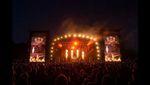 Bloodstock Festival, view of the stage at night, flames and lights with crowd in silhouette.