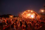 View of the Todd in the Hole Festival main stage at night with a large crowd in the foreground.