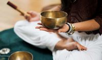 Wellness facilitator holding a sound bowl.