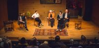 Group of storytelling performers on stage.