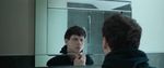 Film still from Precious showing a young man looking into a bathroom mirror.