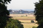 A distant view across the countryside towards the hilltop town of Rye in East Sussex.