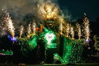 Image of huge Green Man sculpture with fireworks coming out of head and arms.