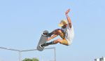 Skateboard rider performing a jump high in the air.
