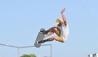 Skateboard rider performing a jump high in the air.