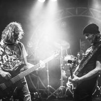 Guitar musicians jamming on stage.