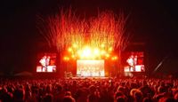 Cross the Tracks Festival main stage at night with confetti streamers.