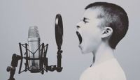 Boy shouting into a microphone.