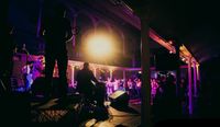 Battle of the Bands at Imbolc Festival, Northern Ireland. Musicians on stage with crowd.