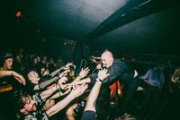 Music performer reaching out to crowd at Outer Town Festival, Bristol, UK.
