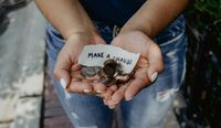 Person holding their hands out with coins and a note which says 'make a change'.