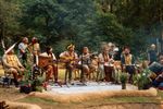 Musician performers at Medicine Festival, on a land stage with forest in the background.