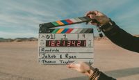 Second assistant camera holding a clapperboard.