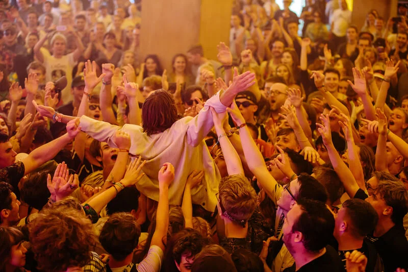 Performer at the Y Not Festival being lifted through the crowd on outstretched arms.