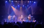 Band performing on stage under blue, orange and purple lighting at Stage4Beverley
